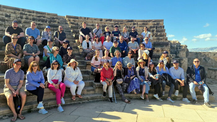 The participants in the Emerge meeting sitting together in an amphitheatre in an archaeological park in Paphos.