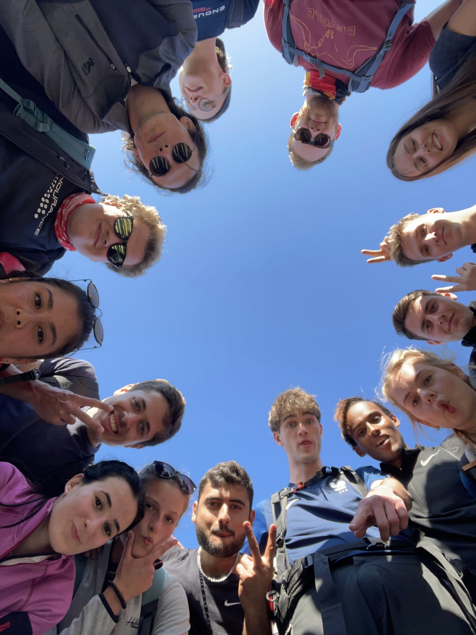 Exchange students standing in a circle and smiling to the camera