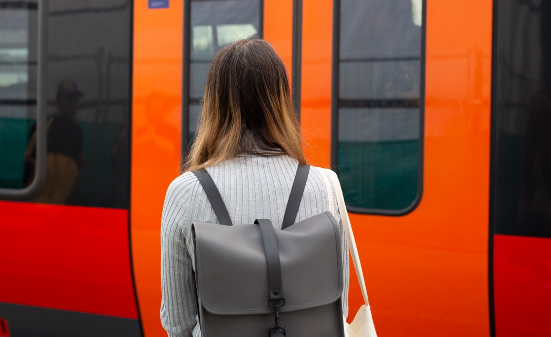 Student standing in front of the train doors